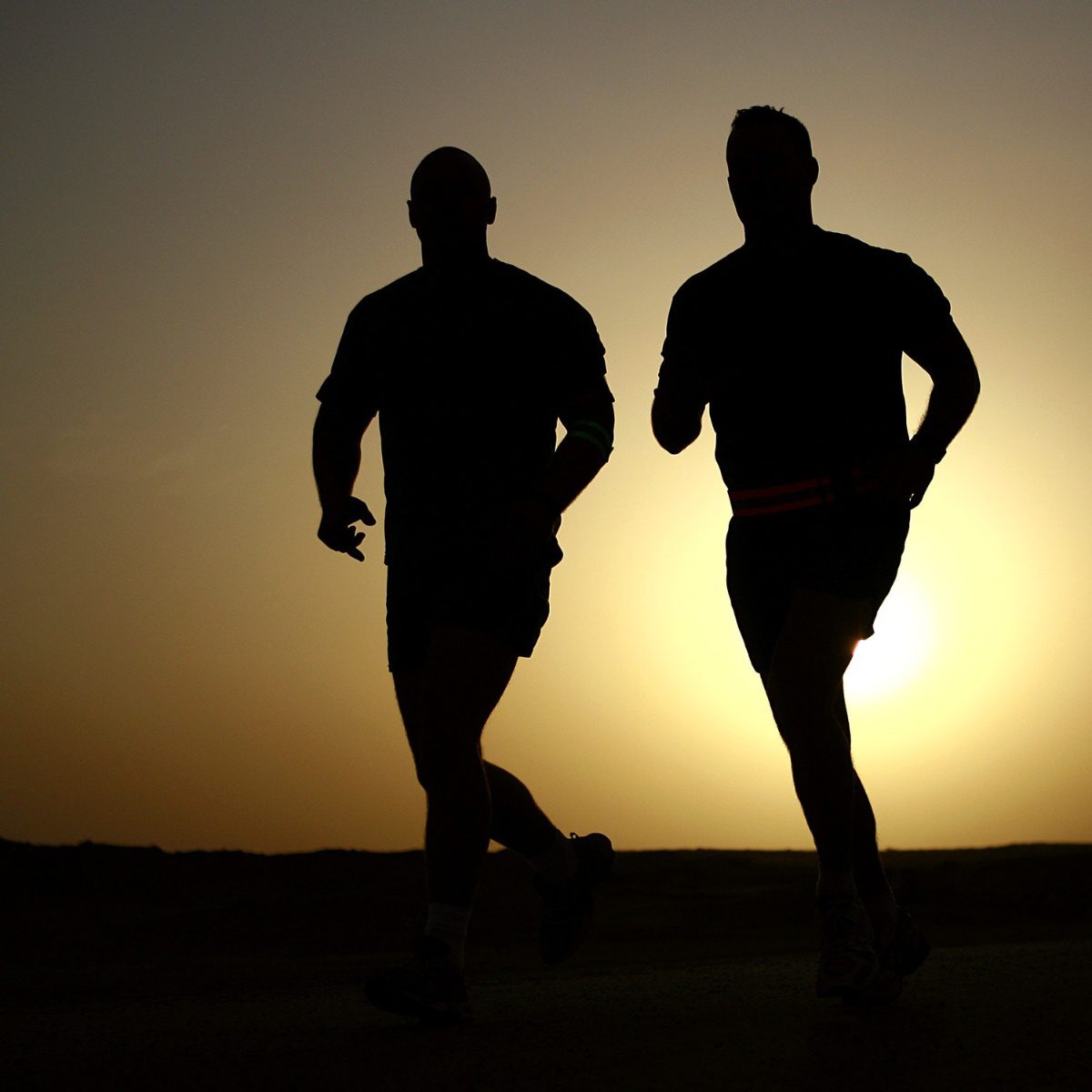 two people running silhouettes