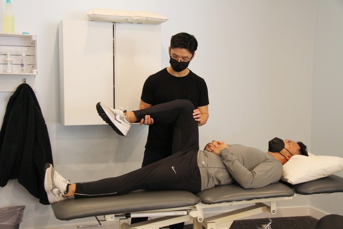 physical assessment of leg with physiotherapist